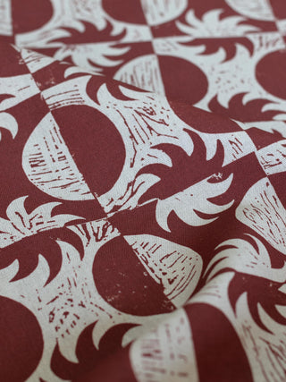 Close up of red and white sun and moon print linen fabric Solstice by contemporary artist Zoe Gibson