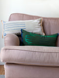 Cushion in green Envy colourway, screenprinted hand shape on linen with duck feather